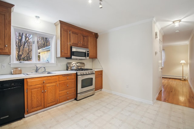 kitchen featuring sink, crown molding, a baseboard radiator, and appliances with stainless steel finishes