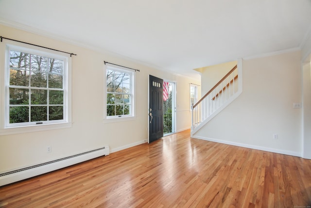 foyer featuring crown molding, light hardwood / wood-style flooring, and baseboard heating