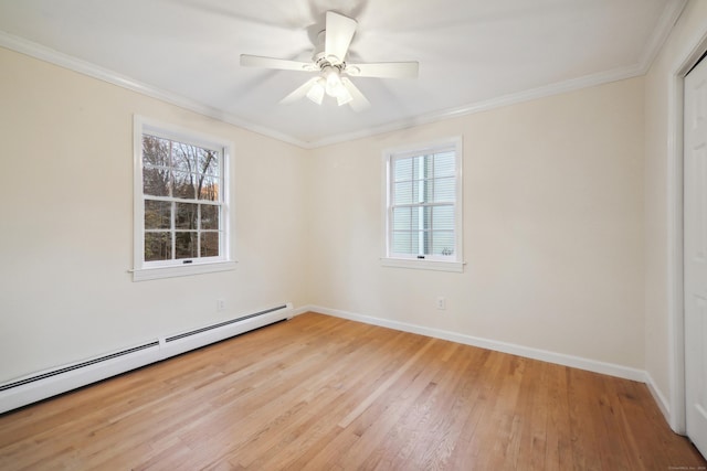 spare room featuring a baseboard radiator, a wealth of natural light, ceiling fan, and light hardwood / wood-style flooring