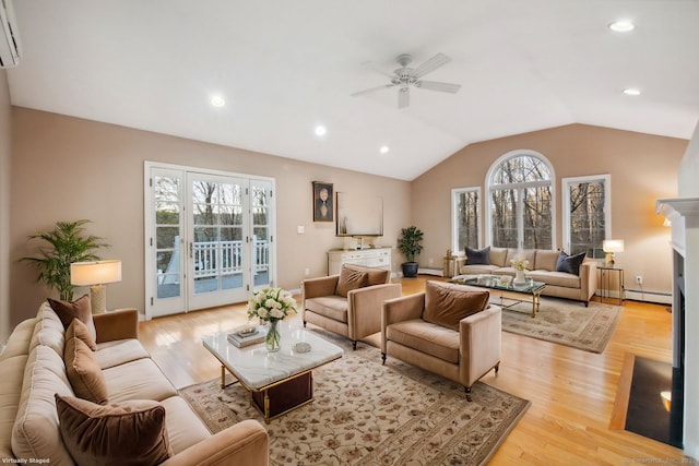 living room featuring vaulted ceiling, baseboard heating, ceiling fan, a wall unit AC, and light hardwood / wood-style flooring