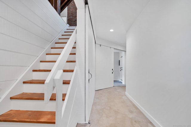 stairway featuring concrete flooring