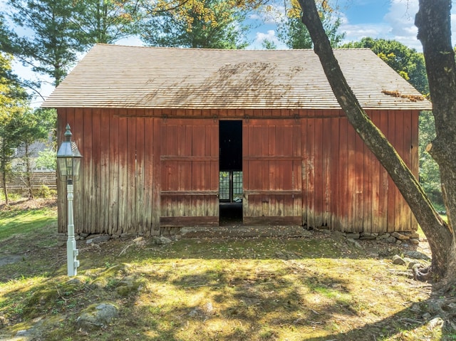 view of outdoor structure featuring a lawn