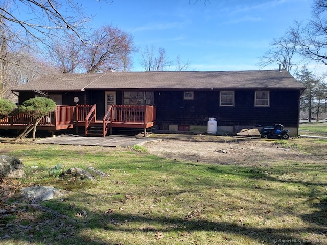 back of house featuring a deck and a yard