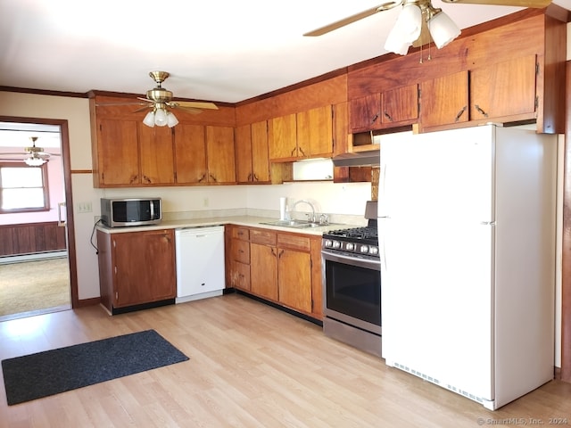 kitchen featuring crown molding, sink, light hardwood / wood-style flooring, and stainless steel appliances