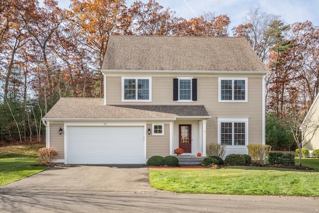 view of front of home featuring a garage and a front lawn