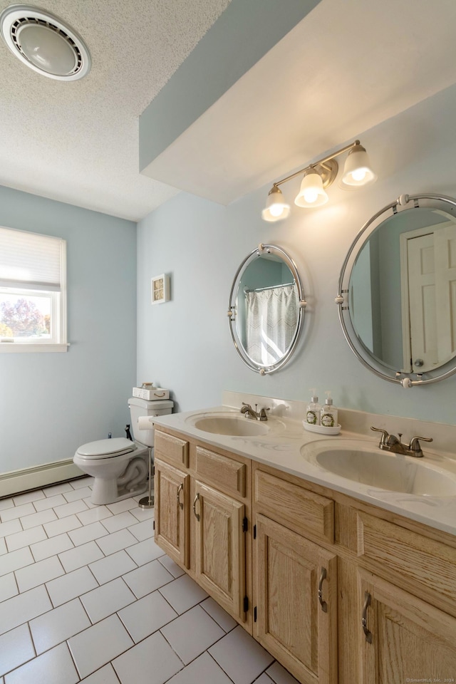 bathroom with baseboard heating, tile patterned floors, a textured ceiling, toilet, and vanity