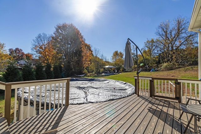 wooden terrace featuring a gazebo and a yard