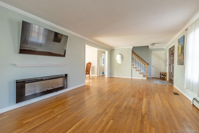 unfurnished living room featuring light hardwood / wood-style flooring and crown molding