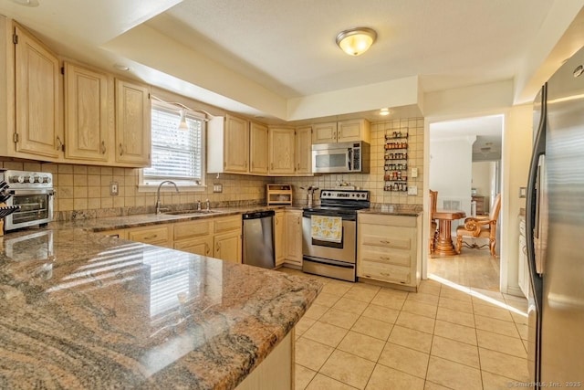 kitchen featuring appliances with stainless steel finishes, light brown cabinets, and light tile patterned floors