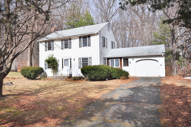 colonial house with an attached garage and driveway