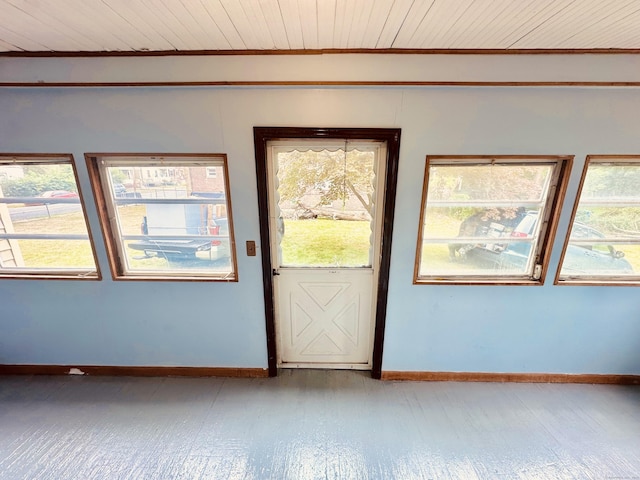 unfurnished room featuring light wood-type flooring, wood ceiling, and baseboards