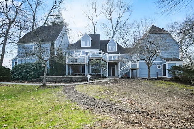 view of front of property featuring a front lawn and a deck