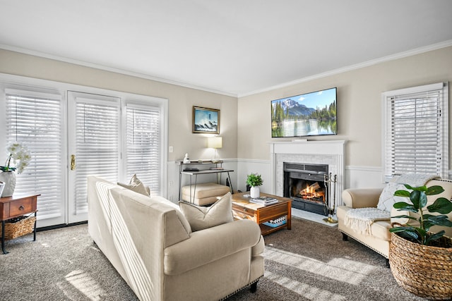 carpeted living room featuring ornamental molding and a tile fireplace