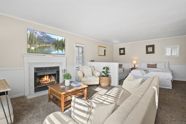 carpeted living room with crown molding and a high end fireplace