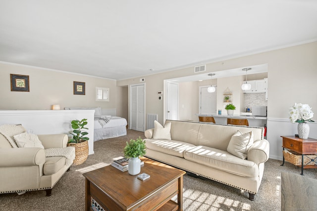 carpeted living room with ornamental molding