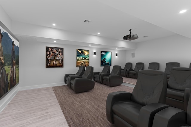 cinema room with light wood-type flooring