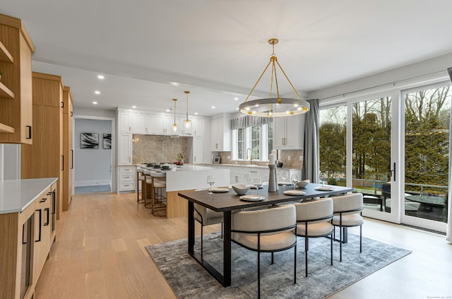 dining room featuring a chandelier and light wood-type flooring