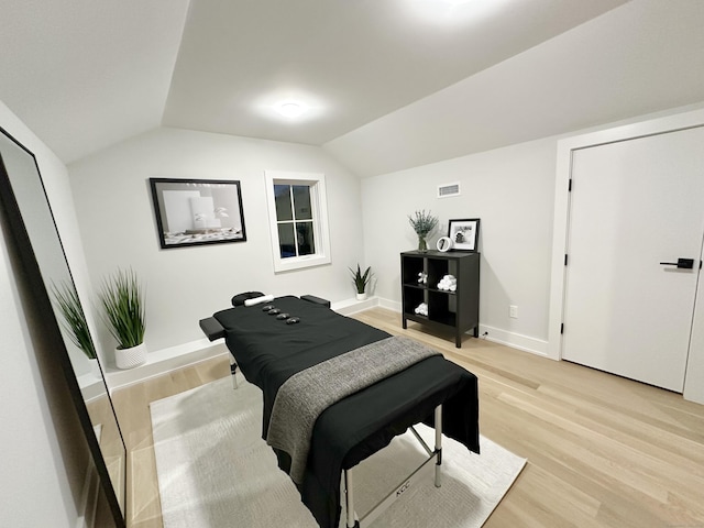 interior space featuring vaulted ceiling and light hardwood / wood-style floors