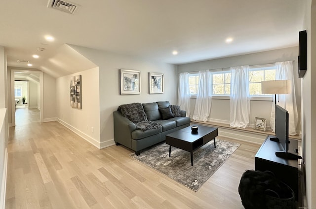 living room with lofted ceiling and light hardwood / wood-style floors