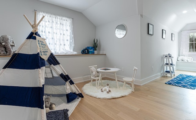 bedroom with wood-type flooring and vaulted ceiling