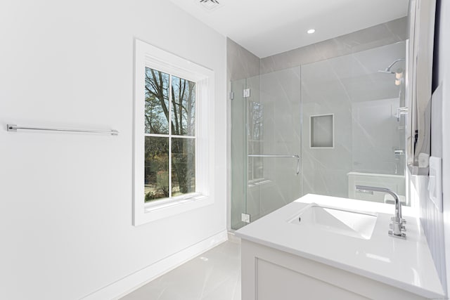 bathroom with vanity and a shower with shower door