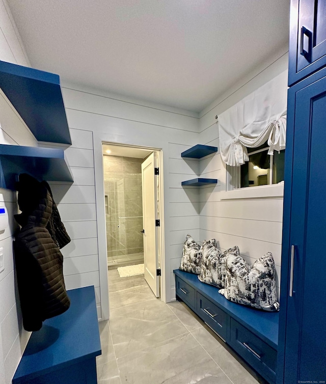 mudroom with wooden walls