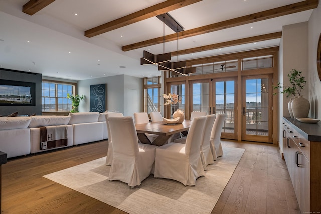 dining space featuring light hardwood / wood-style flooring, french doors, and beamed ceiling