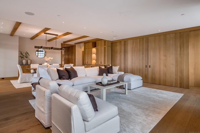 living room with beamed ceiling and hardwood / wood-style flooring