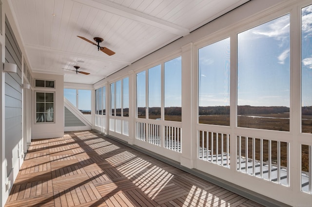 unfurnished sunroom with beamed ceiling, ceiling fan, and wooden ceiling