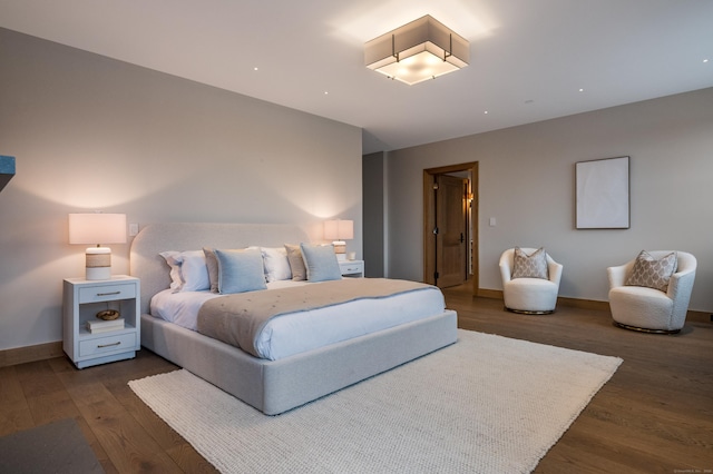 bedroom with dark hardwood / wood-style flooring