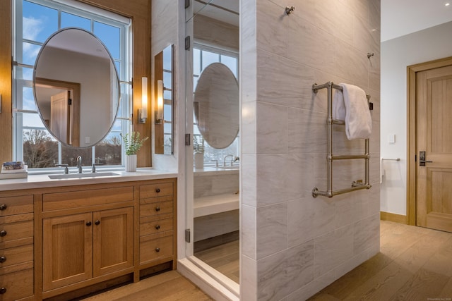 bathroom featuring vanity, hardwood / wood-style floors, and a shower