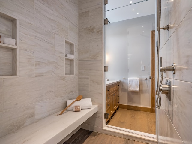 bathroom with vanity and tiled shower