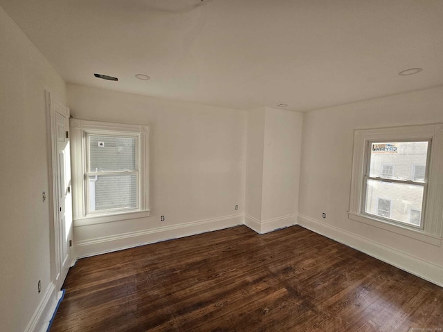 spare room featuring dark hardwood / wood-style flooring