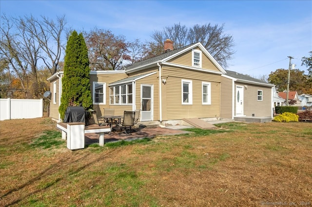 back of property featuring a patio area and a lawn