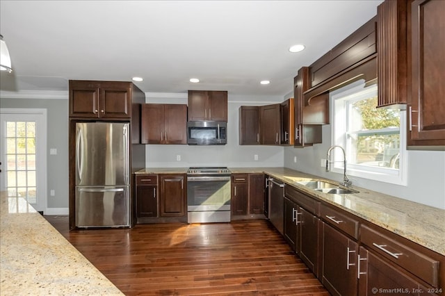 kitchen featuring appliances with stainless steel finishes, a wealth of natural light, sink, and dark hardwood / wood-style flooring