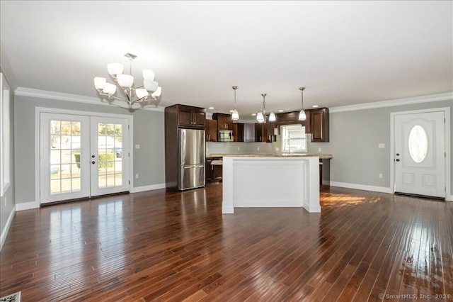 kitchen featuring stainless steel appliances, a center island, dark hardwood / wood-style floors, and hanging light fixtures