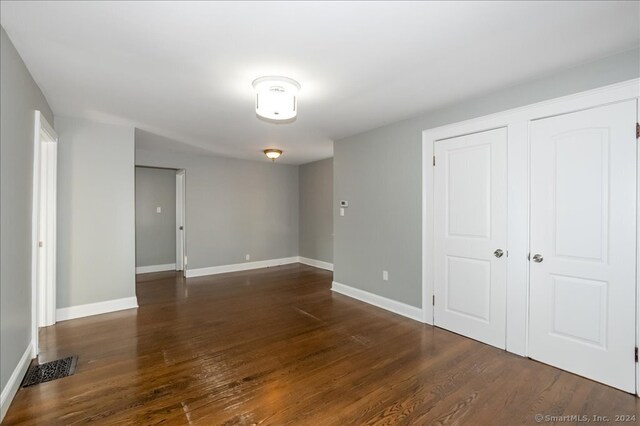 unfurnished room featuring dark hardwood / wood-style floors