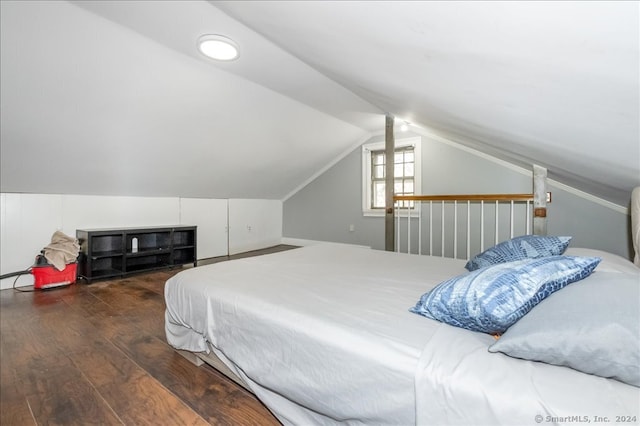 bedroom featuring lofted ceiling and dark hardwood / wood-style flooring