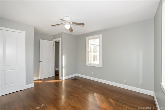 unfurnished bedroom with ceiling fan and dark hardwood / wood-style floors