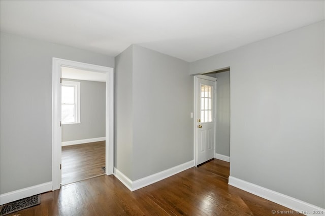 spare room with dark hardwood / wood-style flooring