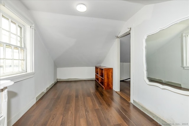 bonus room featuring lofted ceiling and dark hardwood / wood-style flooring