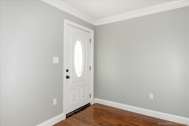 foyer entrance with ornamental molding and wood-type flooring