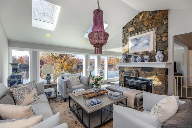 living room with a fireplace, lofted ceiling with skylight, and plenty of natural light