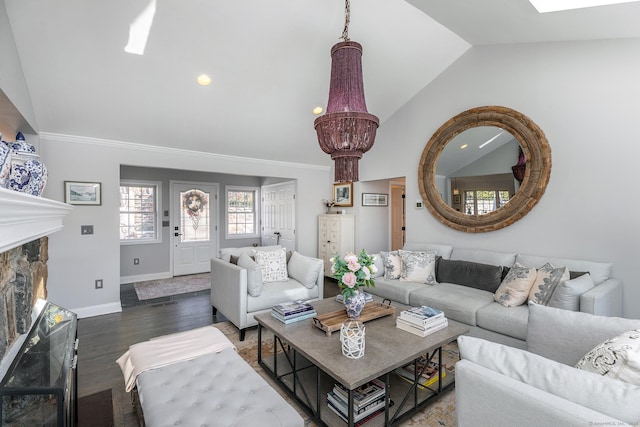 living room with a notable chandelier, a fireplace, dark wood-type flooring, and vaulted ceiling