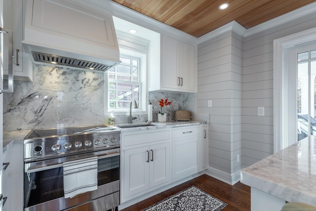 kitchen with white cabinets, sink, stainless steel stove, and wood ceiling