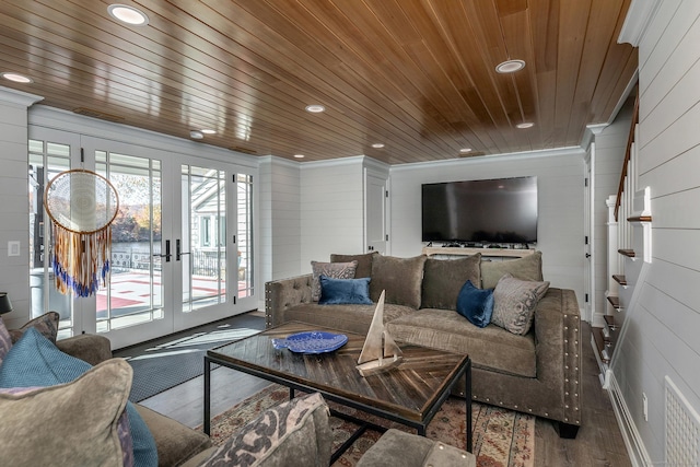 living room featuring french doors, wooden walls, crown molding, and hardwood / wood-style floors