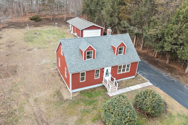 view of front of house featuring a garage and an outbuilding