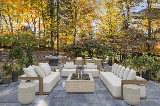 view of patio / terrace with an outdoor living space with a fire pit and area for grilling