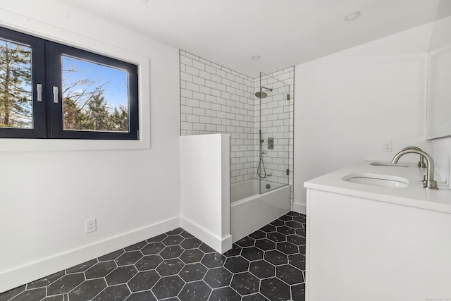 bathroom with tiled shower / bath combo, french doors, and vanity