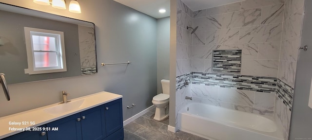 full bathroom with tiled shower / bath combo, toilet, and vanity